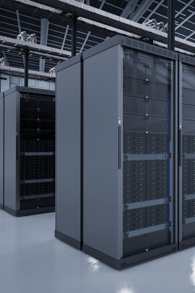 Inside view of a data center with rows of servers and monitoring screens, highlighting the hub of software and security operations.