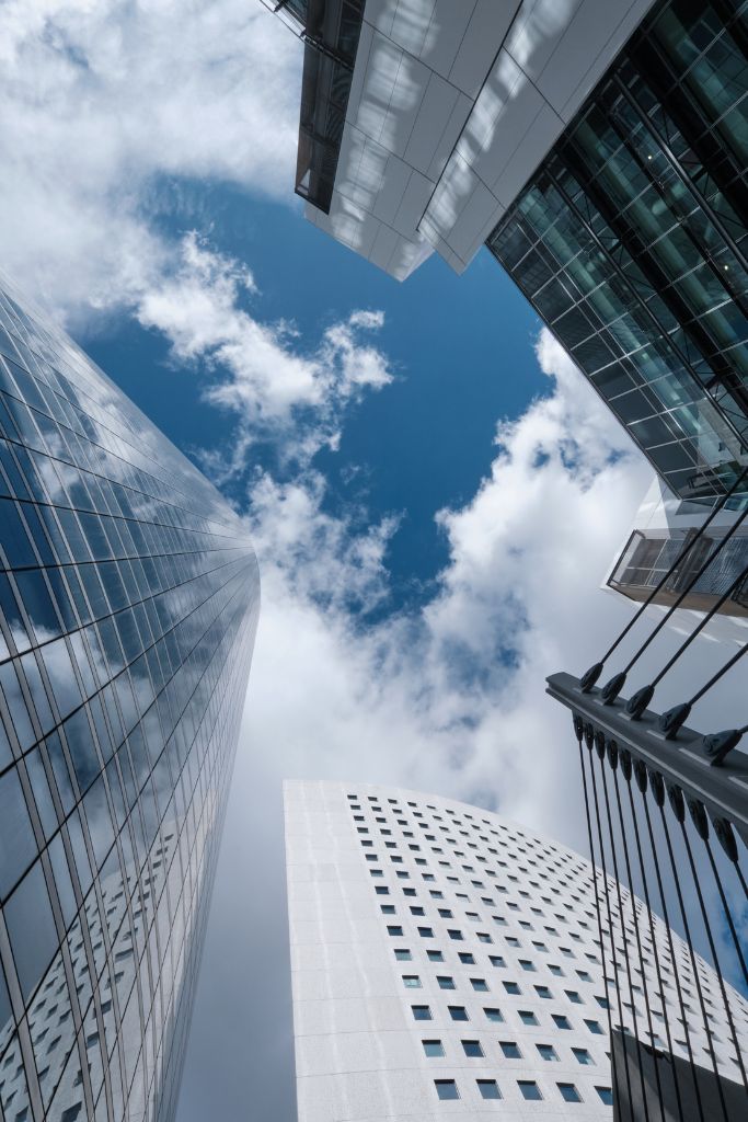 An artistic shot of tall corporate buildings, symbolizing the dynamic real estate market supported by advanced IT solutions.