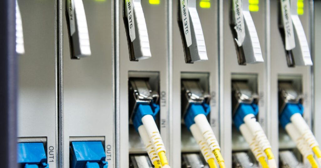 Numerous ethernet cables connected within a bustling data center, highlighting the backbone of reliable network infrastructure.