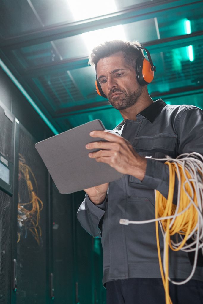 A technician working diligently on hardware, representing the importance of cybersecurity maintenance in Louisville. Our cybersecurity experts prevent threats and maintain robust defenses for local businesses